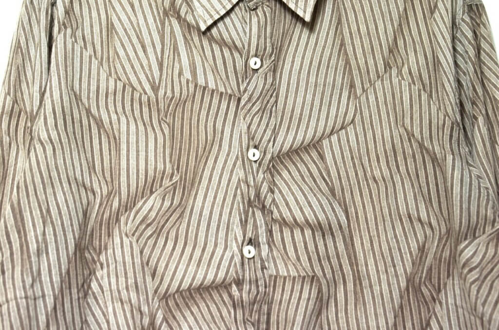 Shirt with wrinkles all over it.